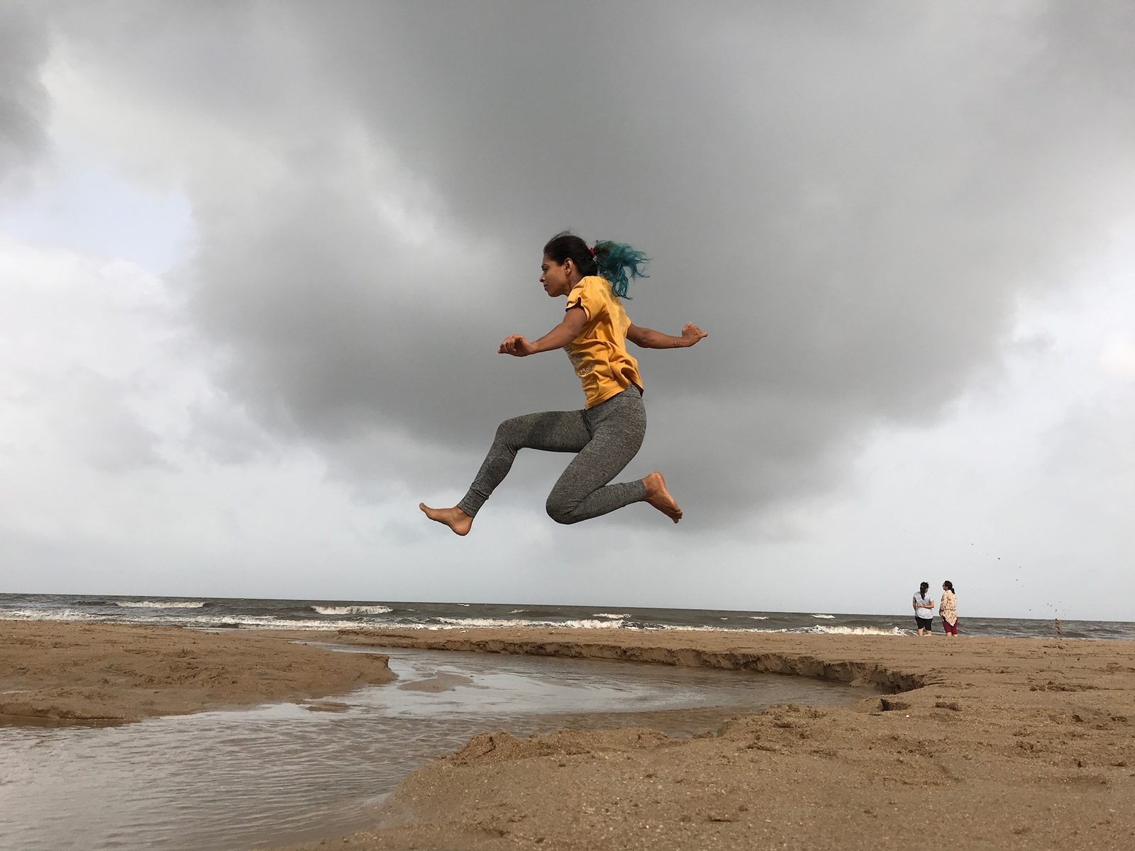 Sudipta Mondal jumping on a stormy Goa beach
